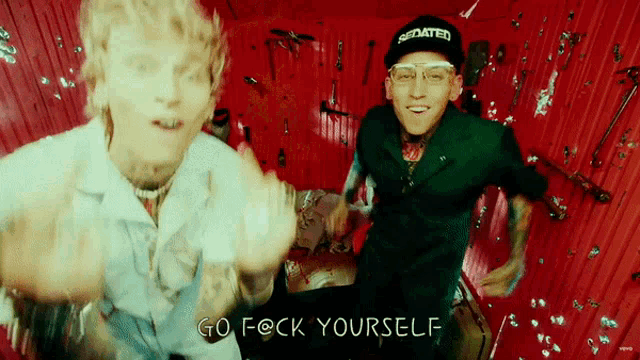 two men are dancing in a room with the words go f * ck yourself on the bottom