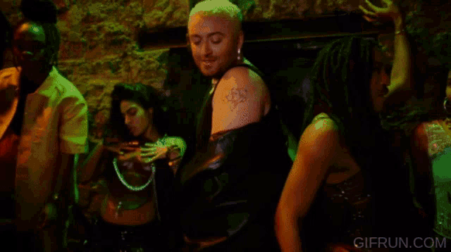 a gif from gifrun.com shows people dancing in a club