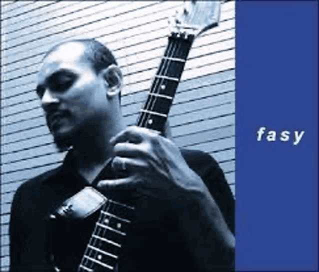 a man in a black shirt is playing a guitar in front of a blue background that says fasy