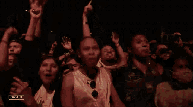 a crowd of people at a concert with a sign that says ' cancella ' on it