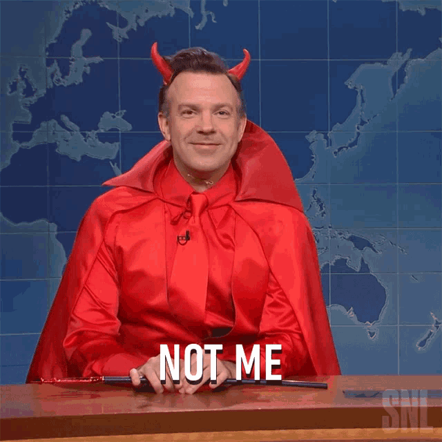 a man dressed in a devil costume says not me