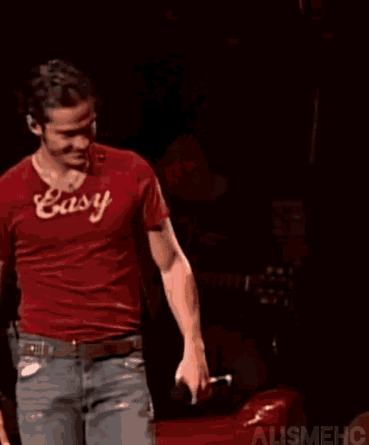 a man in a red shirt that says easy