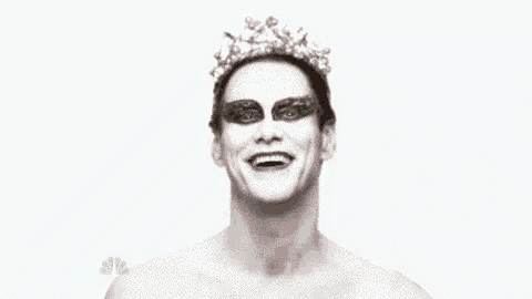 a man with a crown on his head is making a funny face with his mouth open .