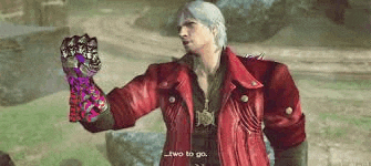 a man in a red jacket is holding a purple glove in his hand .