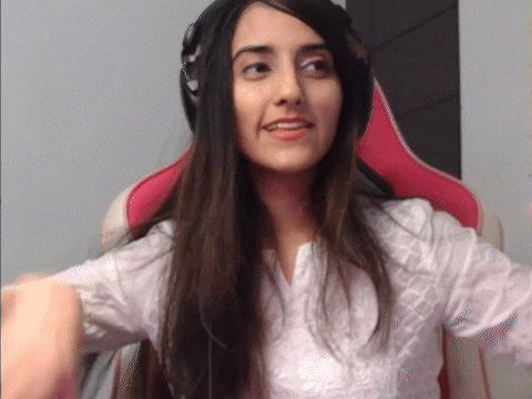 a woman wearing headphones is sitting in a chair