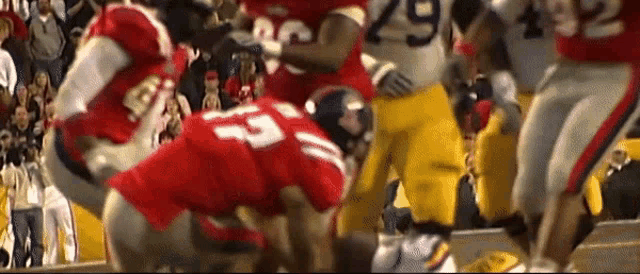 a football player wearing a red jersey with the number 53 on it