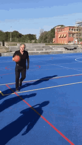 a man is running with a basketball on a court