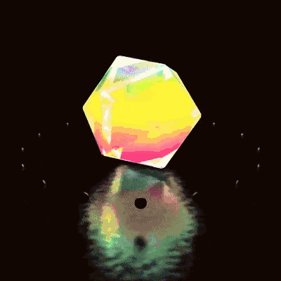 a rainbow colored object with a black hole in the middle