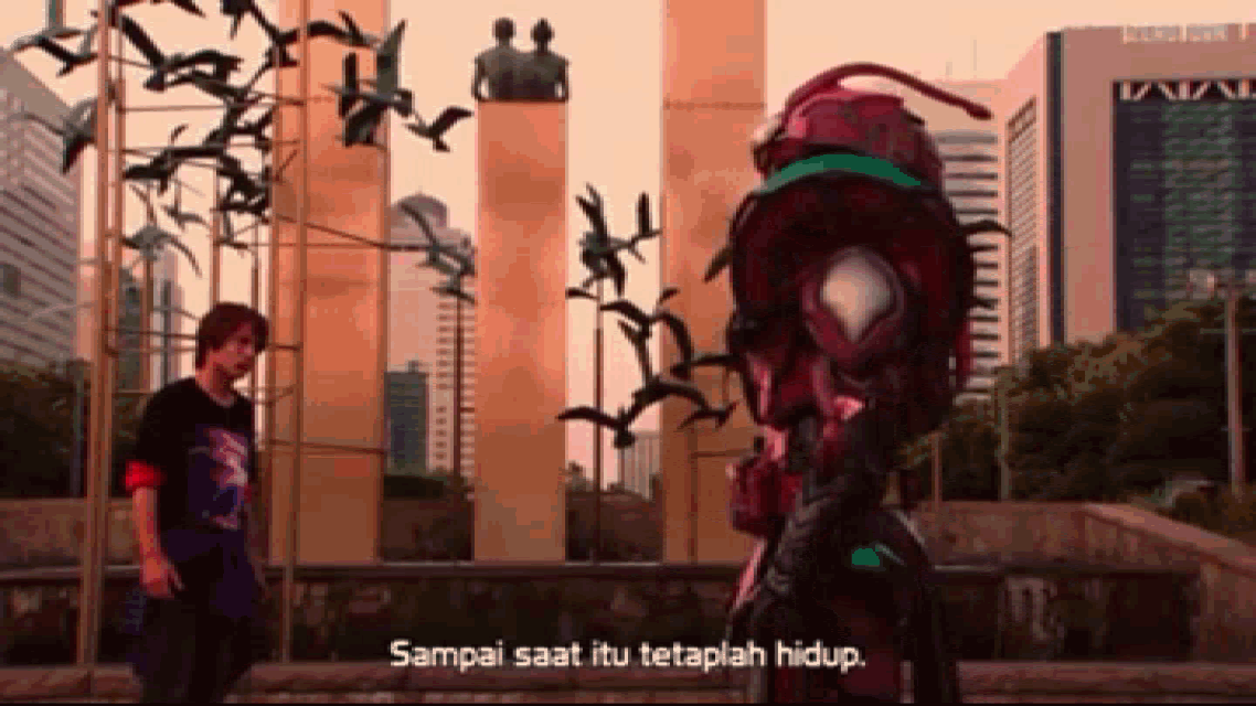 a man standing next to a statue with the words " sampai saat itu terahlah hidup "
