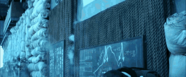 a chalkboard with arrows pointing to different directions is hanging on a wall with a lot of bags