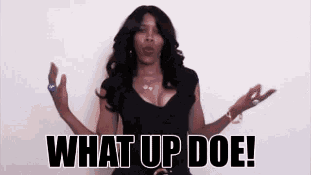a woman in a black dress is making a funny face and saying what up doe .