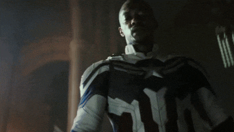a person standing in a dark room with a backpack