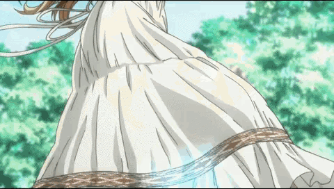 a woman in a long white dress with a brown ribbon around her waist