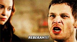 a man is making a funny face while a woman looks on and the man says rebekah