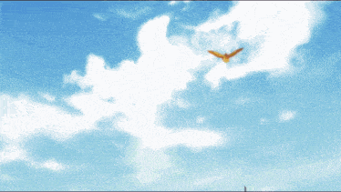 a bird is flying in the blue sky with white clouds