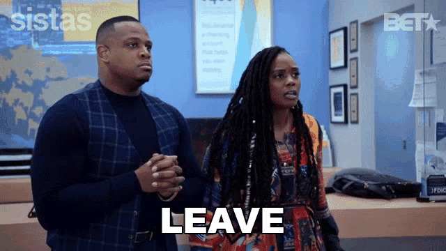 a man and a woman standing next to each other with the word leave written on the screen