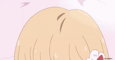 a girl is laying on her stomach on a bed with her legs up in the air .