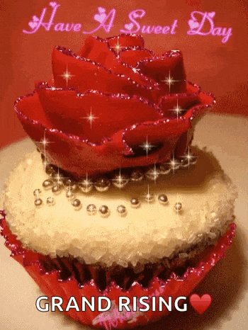a cupcake with a red rose on top and the words have a sweet day grand rising below it