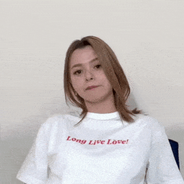 a woman wearing a white t-shirt that says long live love