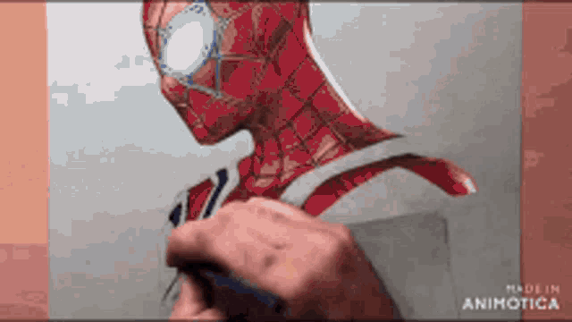 a person is drawing a picture of spider man