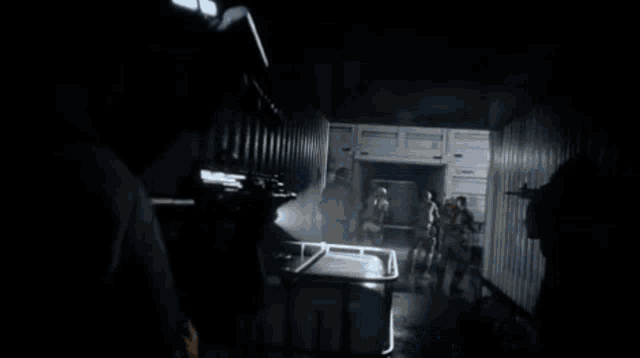a blurry image of a person holding a gun with a red light coming from it
