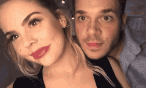 a man and a woman are posing for a picture .