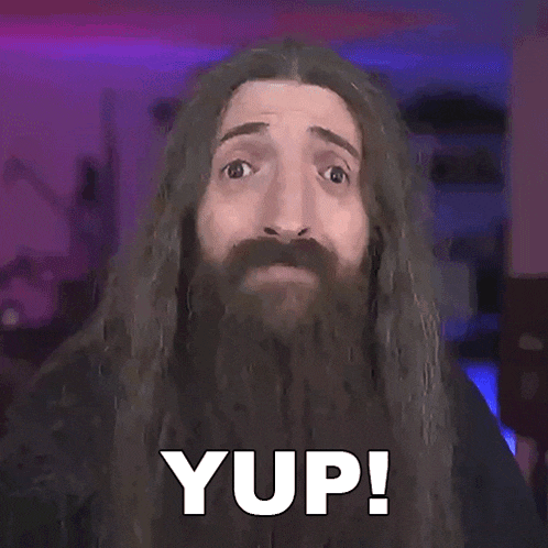 a man with long hair and a beard has the word yup on his face