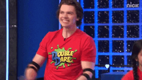 a young man wearing a red double dare shirt