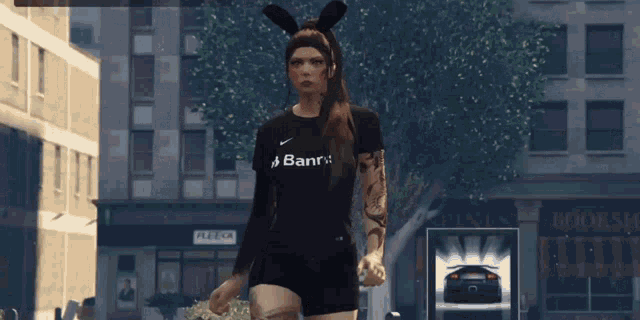 a woman wearing bunny ears and a banri shirt walks down a city street