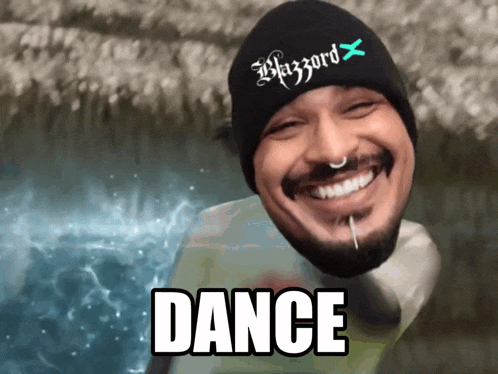 a man wearing a blizzard hat is smiling and the word dance is below him