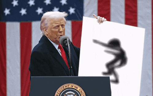 donald trump stands at a podium in front of an american flag