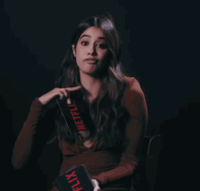 a woman is holding a box that says ' netflix ' on it