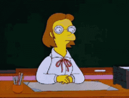 a cartoon character is sitting at a desk with glasses on
