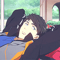 a young man is laying on a bed with his arms outstretched