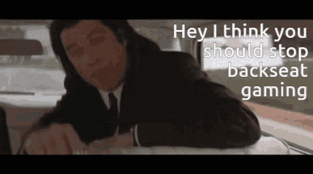 a man in a suit and tie is laying in the back seat of a car and says hey