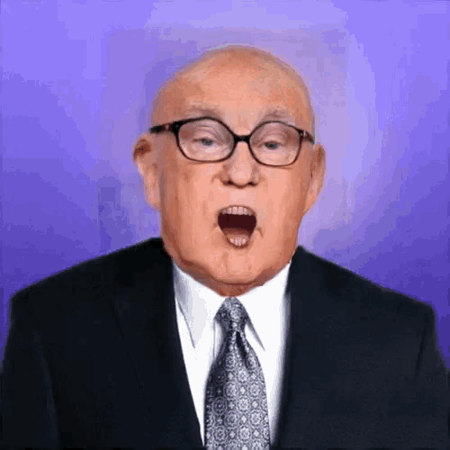 a bald man wearing glasses and a suit and tie with his mouth open
