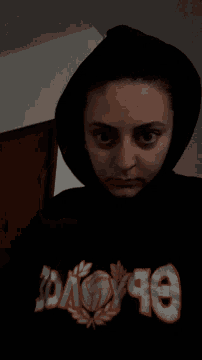a girl wearing a black hoodie with the word boys on the front