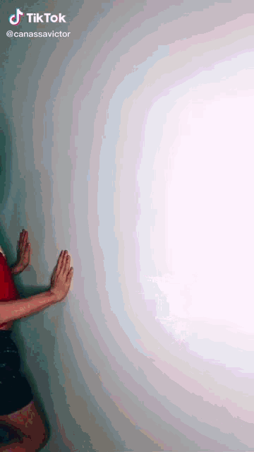a tiktok video of a woman leaning on a wall