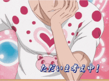 a man wearing a white shirt with pink polka dots and a pink teddy bear