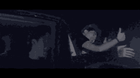a blurry picture of a person standing in a dark room with a light shining on them