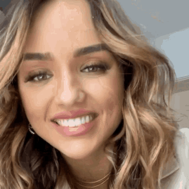 a close up of a woman 's face smiling with her mouth open