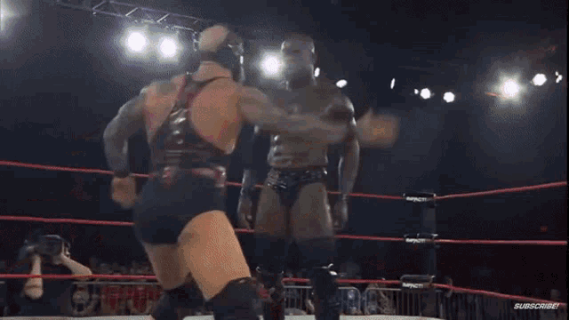 two wrestlers are fighting in a ring with a sign that says impact 20 on it
