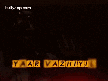 a man wearing glasses is making a funny face and says yaar vazhiyil .