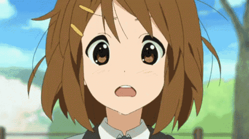 a close up of a girl 's face with a surprised look on her face