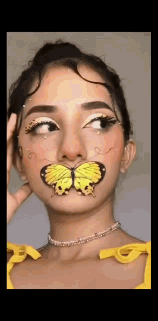 the woman has a butterfly painted on her face .