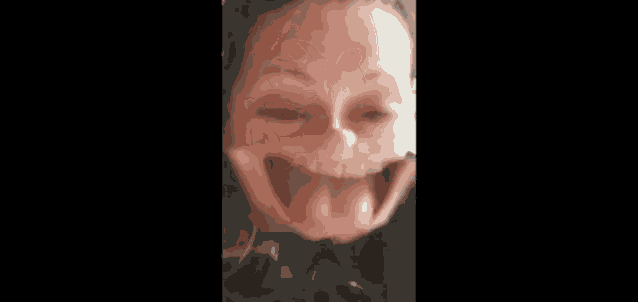 a blurry picture of a person blowing a cigarette .