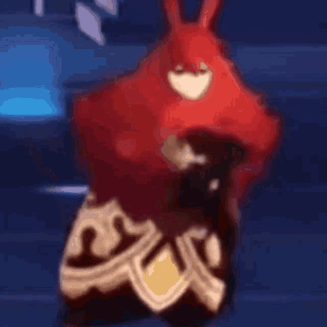 a red cartoon character with a shield and a heart on his chest
