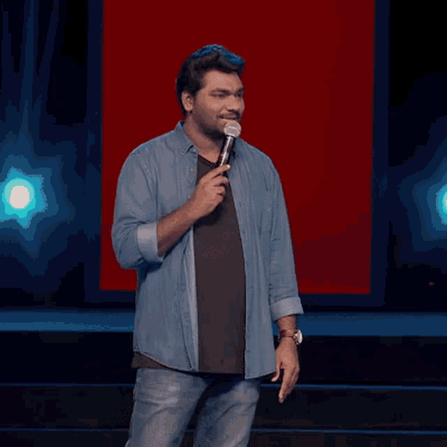 a man holding a microphone says it 's a moment