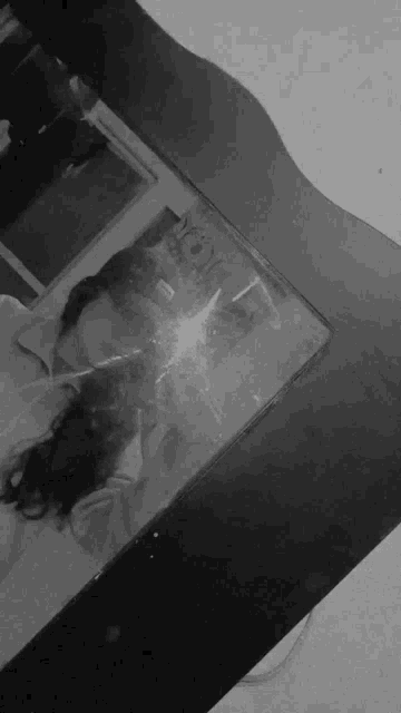 a black and white photo of a person taking a selfie in front of a mirror