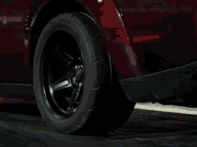 a close up of a car wheel with smoke coming from it
